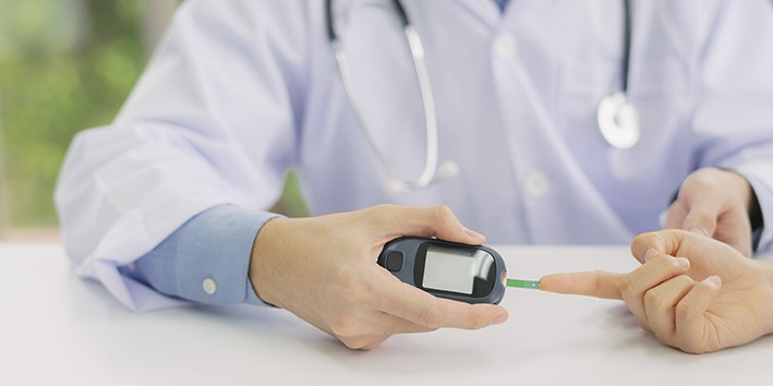 Medico medindo diabetes